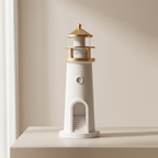 Model of a lighthouse on a white surface with a neutral background