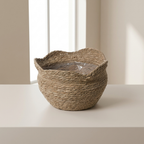 Woven basket on a white surface with a neutral background