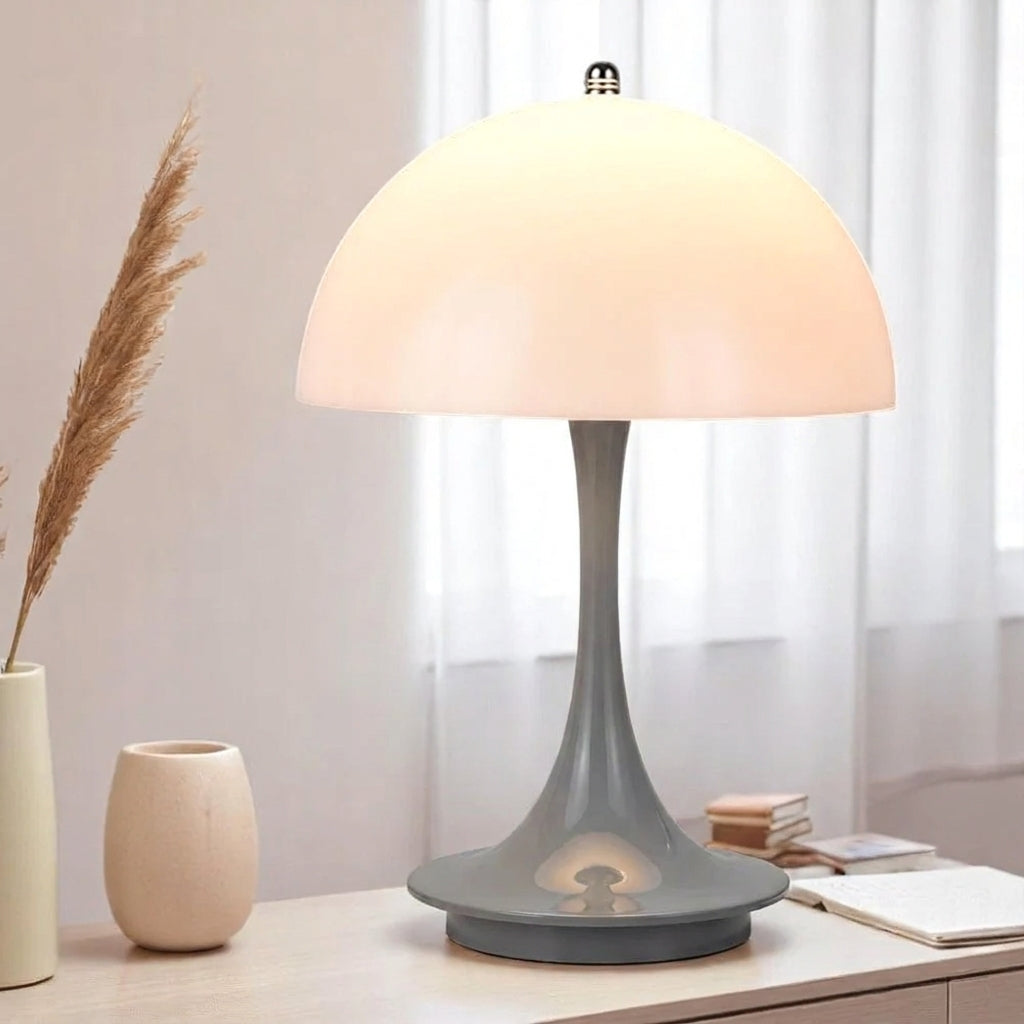 Table lamp on a surface with decorative items in a softly lit room