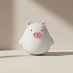 White pig-shaped night light on a beige background