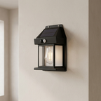 Solar-powered outdoor wall light fixture on a neutral wall.