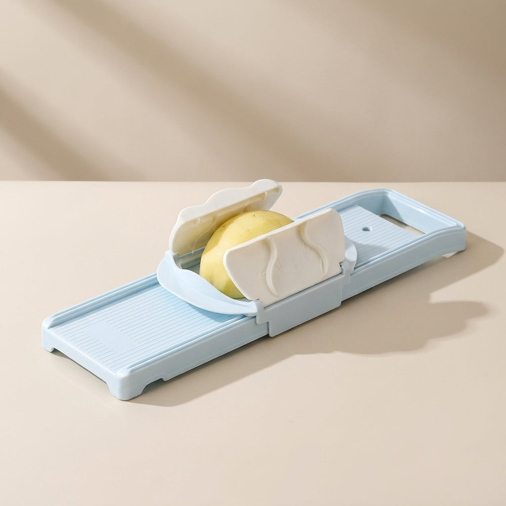 Sliced apple on a mandoline slicer against a beige background