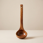 Wooden ladle on a beige background