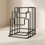 Black metal magazine rack on a beige background