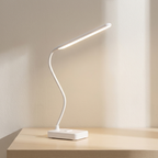 Modern LED desk lamp with flexible neck on a wooden surface.