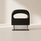 Black meat tenderizer on a beige background
