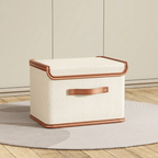 Beige storage box with brown trim on a wooden floor