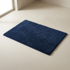 Navy blue rug on a light beige floor
