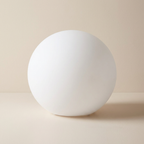 White spherical object on a beige background