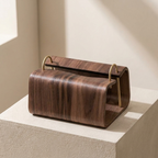 Wooden magazine holder with gold accents on a neutral background