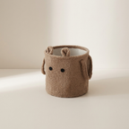 Brown woven basket with a face on a beige background
