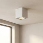 Square ceiling light fixture on a beige ceiling