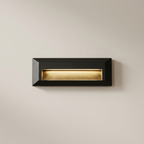 Black letterbox with gold interior on a beige wall