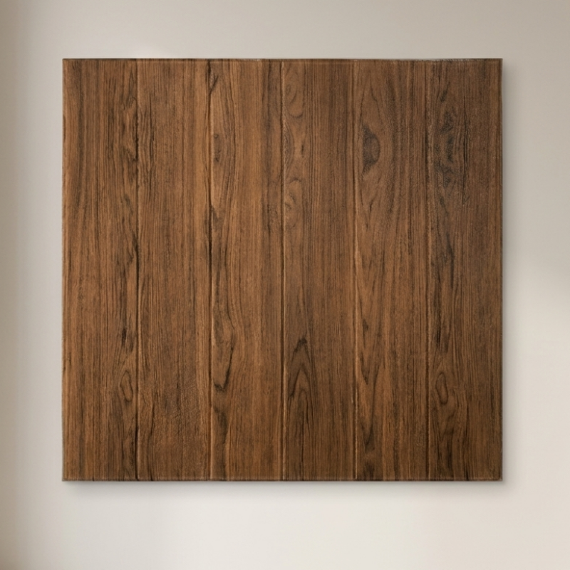 A square wall art panel with a vertical wood plank pattern in medium to dark brown, mounted on a light beige wall next to a window.