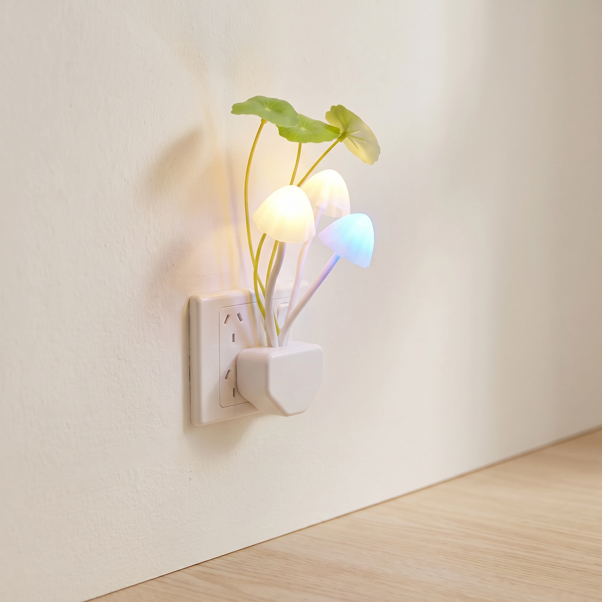 A wall-plugged night light shaped like a small plant with glowing mushroom-shaped bulbs in white, warm yellow, and blue, set against a beige wall and light wood floor.