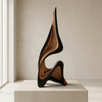 Abstract sculptural wall art with layered wavy forms in black and warm brown wood tones, displayed on a pedestal in a minimalist interior setting.