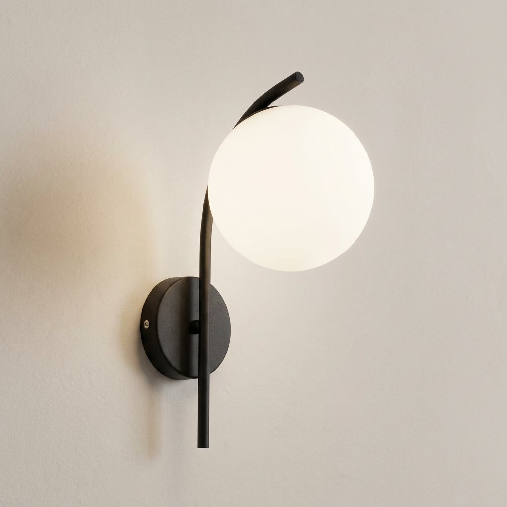 Modern wall sconce with a matte black curved metal frame and a large frosted white globe shade, mounted on a light beige wall.