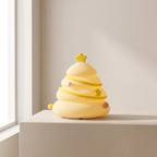 A small yellow tree-shaped lamp with a star topper sits on a beige tabletop against a warm off-white wall near a window.