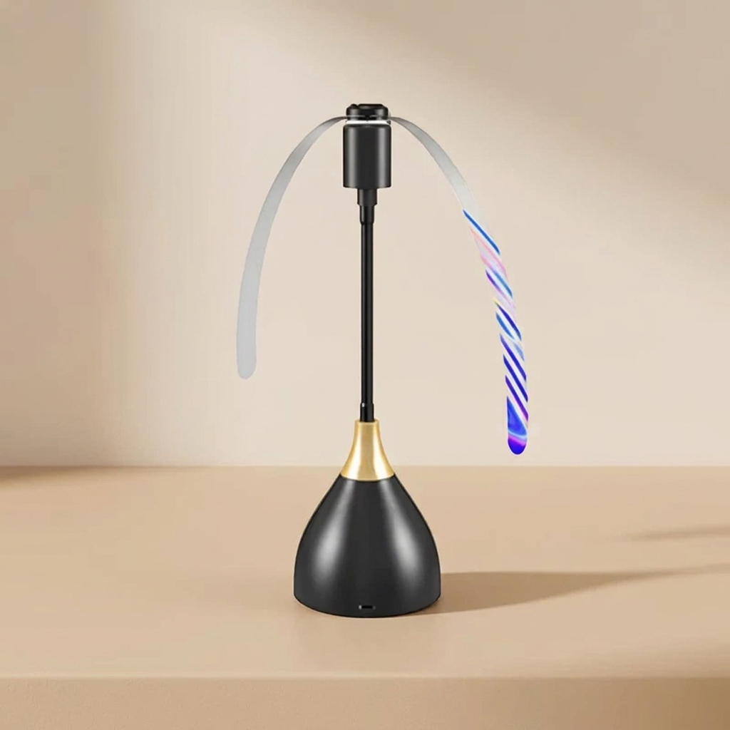 A modern desk lamp with a black conical base, a gold neck accent, and a black vertical stem. A flexible translucent sweep arm arches over the top, and a striped wand-like arm glows with blue and purple LED light.