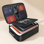 A black textured expandable document organizer suitcase shown open, filled with travel documents, passports, and small accessories, on a warm beige studio background.