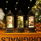 Three decorative lanterns with Christmas scenes inside, on a wooden surface with festive decorations.