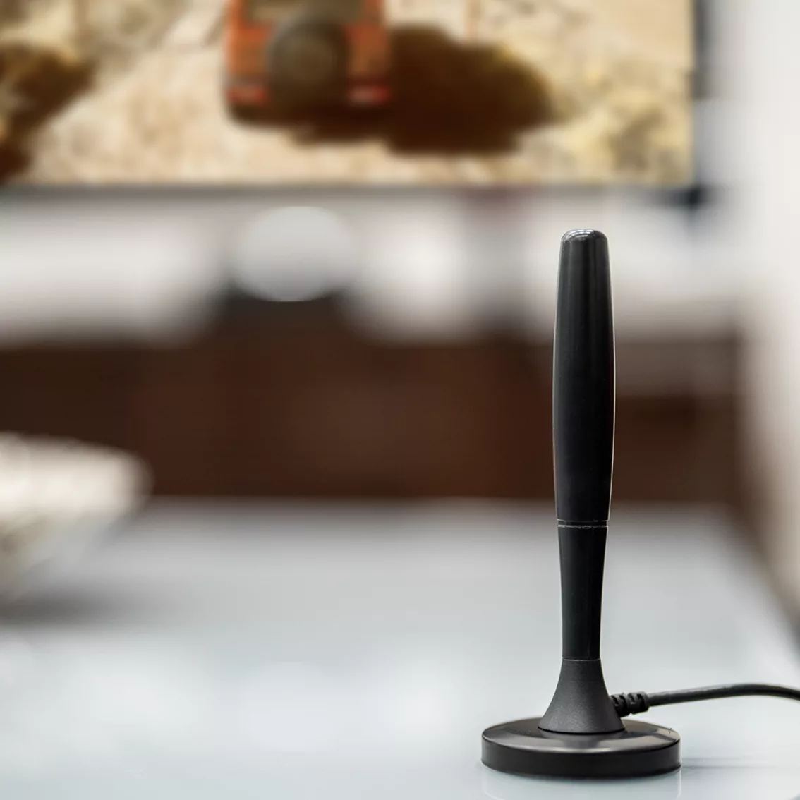Black antenna on a table with a blurred background