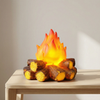 Fire pit lamp with glowing flames and wooden logs on a table against a neutral background
