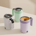 Three insulated travel mugs in white, green, and purple on a light surface.