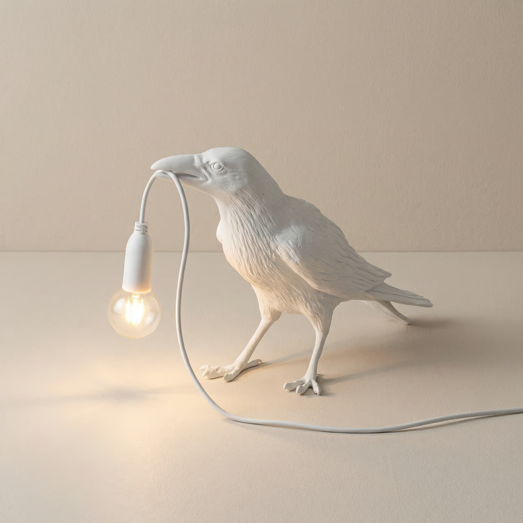 White bird-shaped lamp holding a light bulb on a beige background