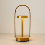 Gold table lamp with a curved design on a neutral background
