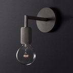 Wall-mounted light fixture with a single bulb on a dark background