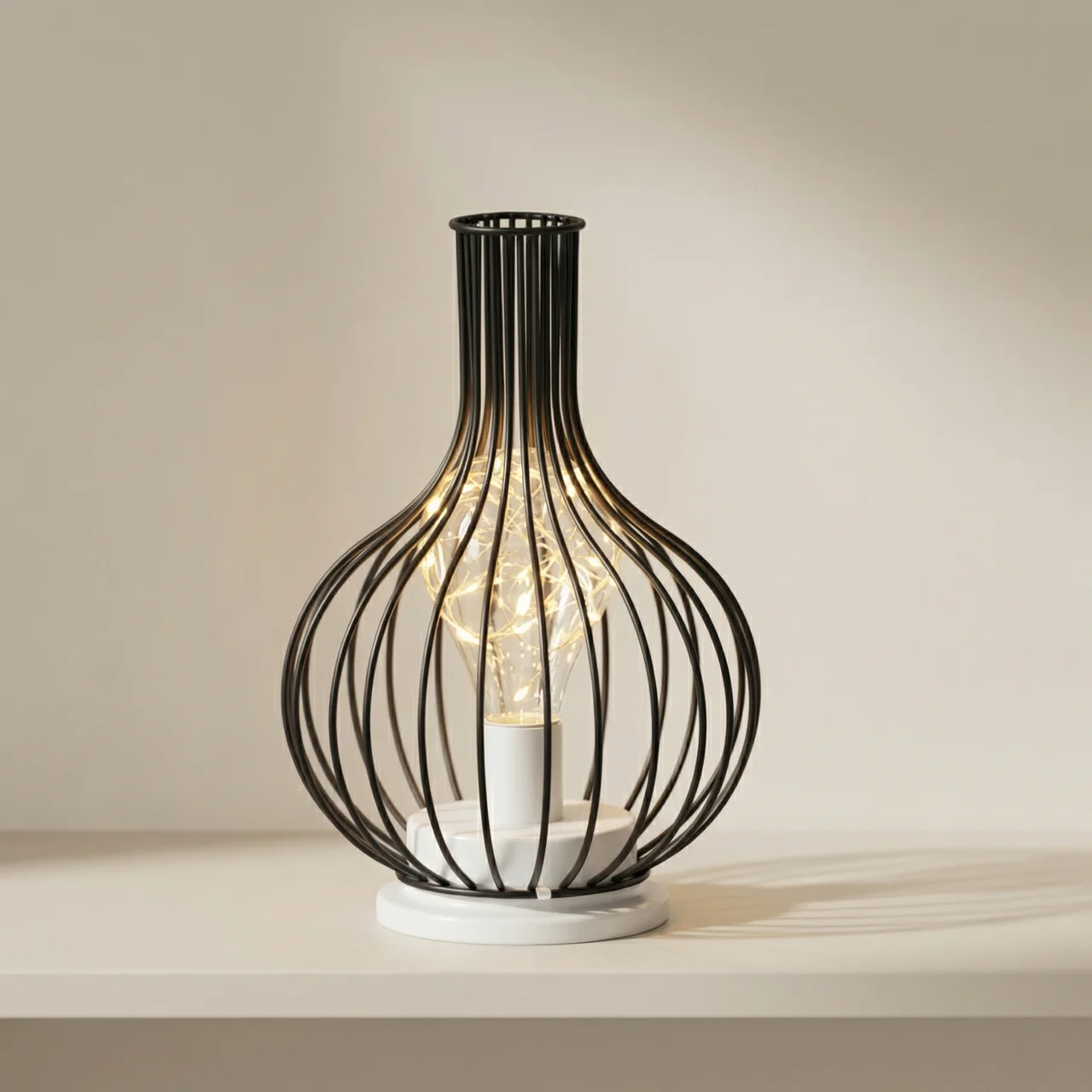 Decorative table lamp with black wire cage design on a neutral background