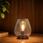 Decorative table lamp with mesh design on a wooden surface