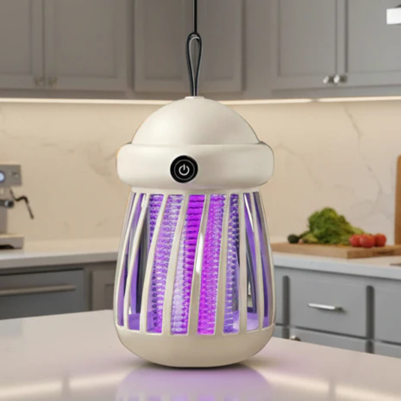 Fogging lamp on a kitchen counter with purple light, surrounded by kitchen appliances and vegetables.