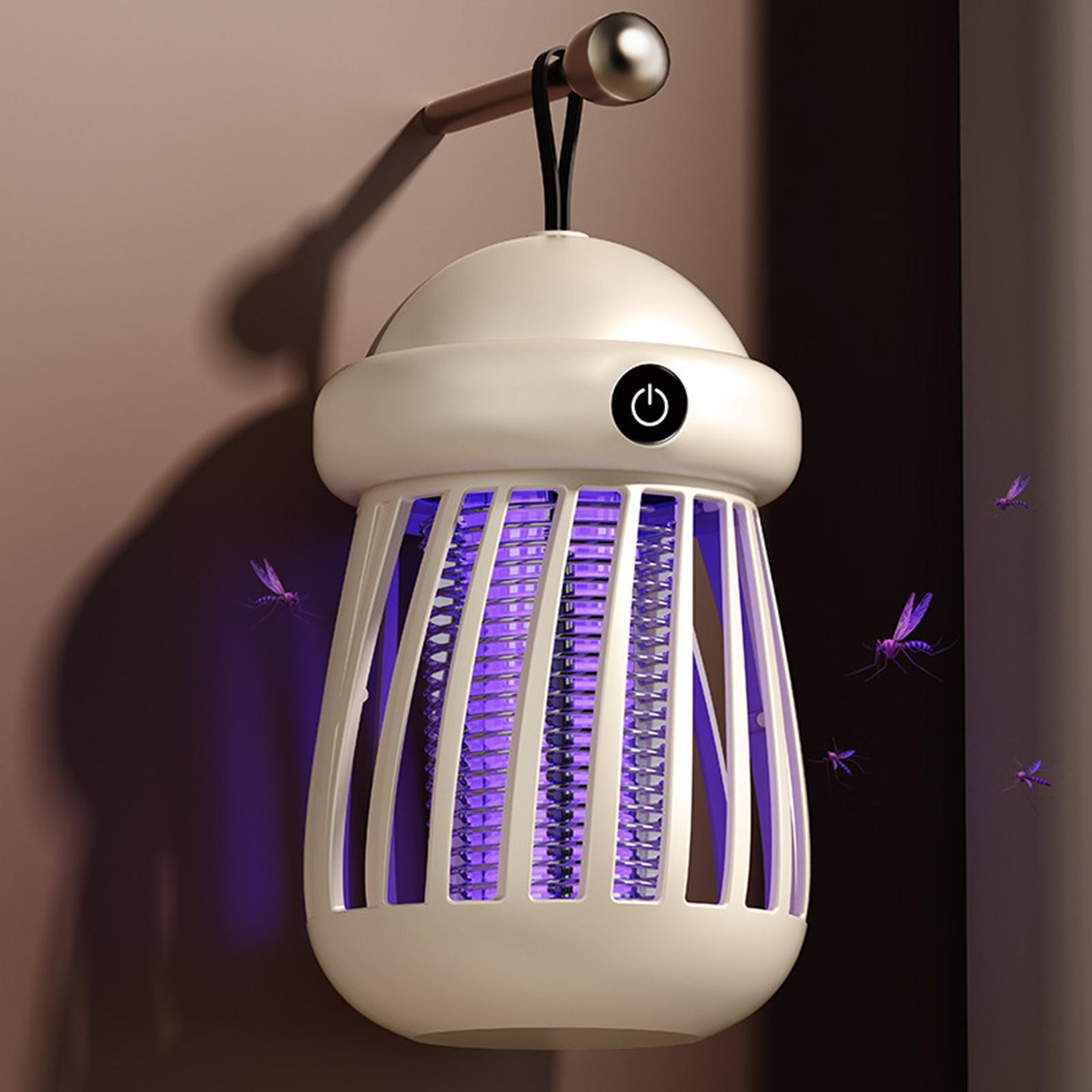White electronic insect killer with purple light on a dark background