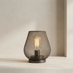 Decorative table lamp with mesh design on a neutral background