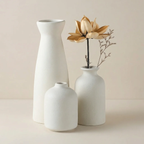 Three white vases of different shapes on a beige background