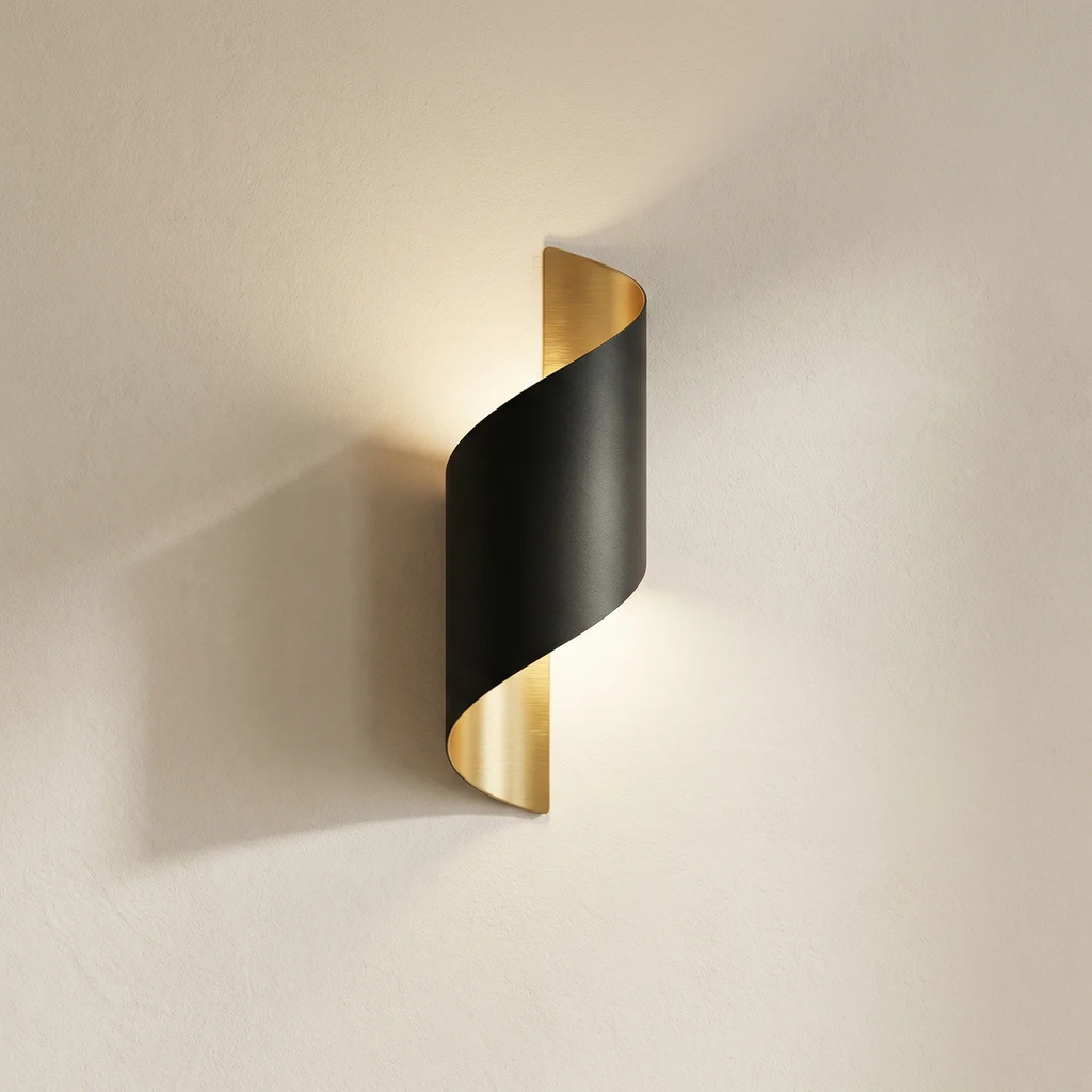 Modern wall light fixture with black and gold design on a neutral background