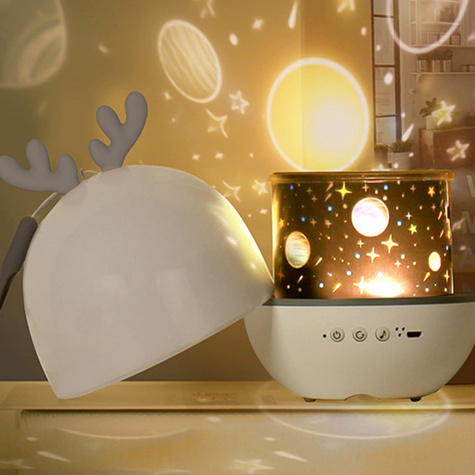 Decorative night light with reindeer design and planetarium projector on a yellow background