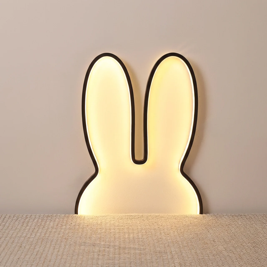 Rabbit-shaped wall lamp on a neutral background