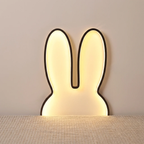 Rabbit-shaped wall lamp on a neutral background