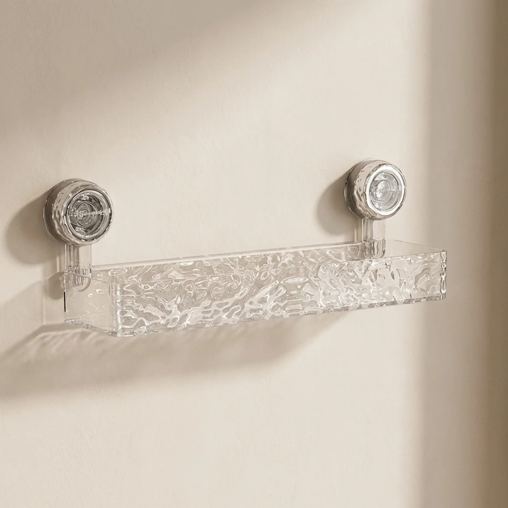Clear glass shelf with decorative knobs on a beige wall