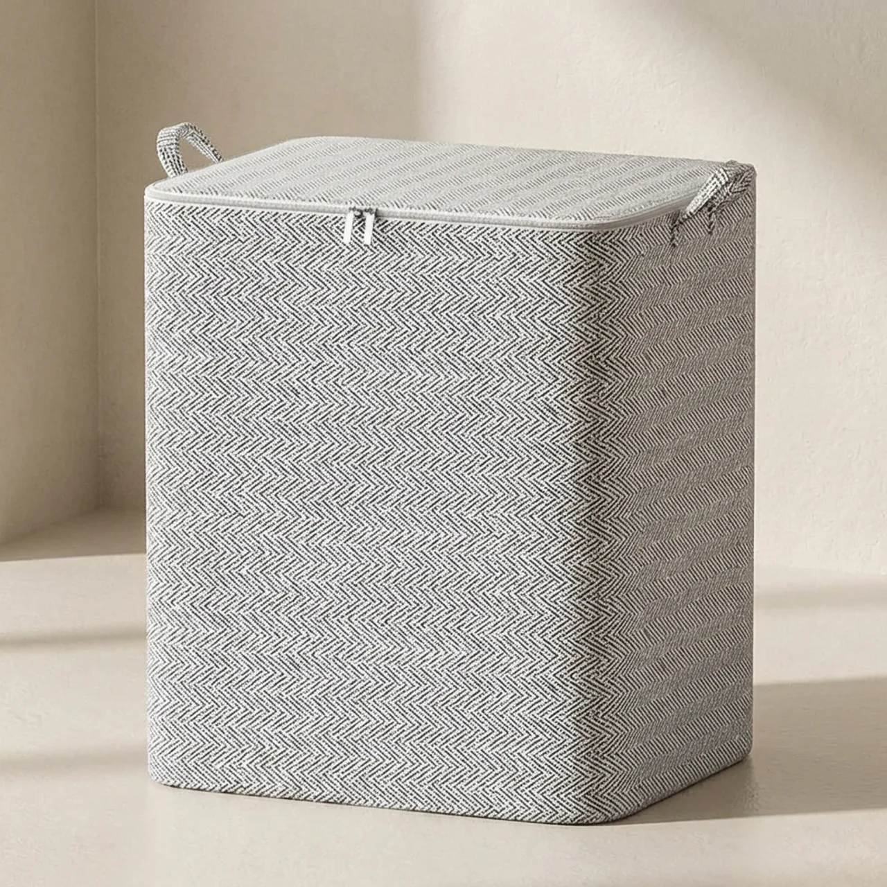 Gray herringbone patterned laundry basket on a beige background
