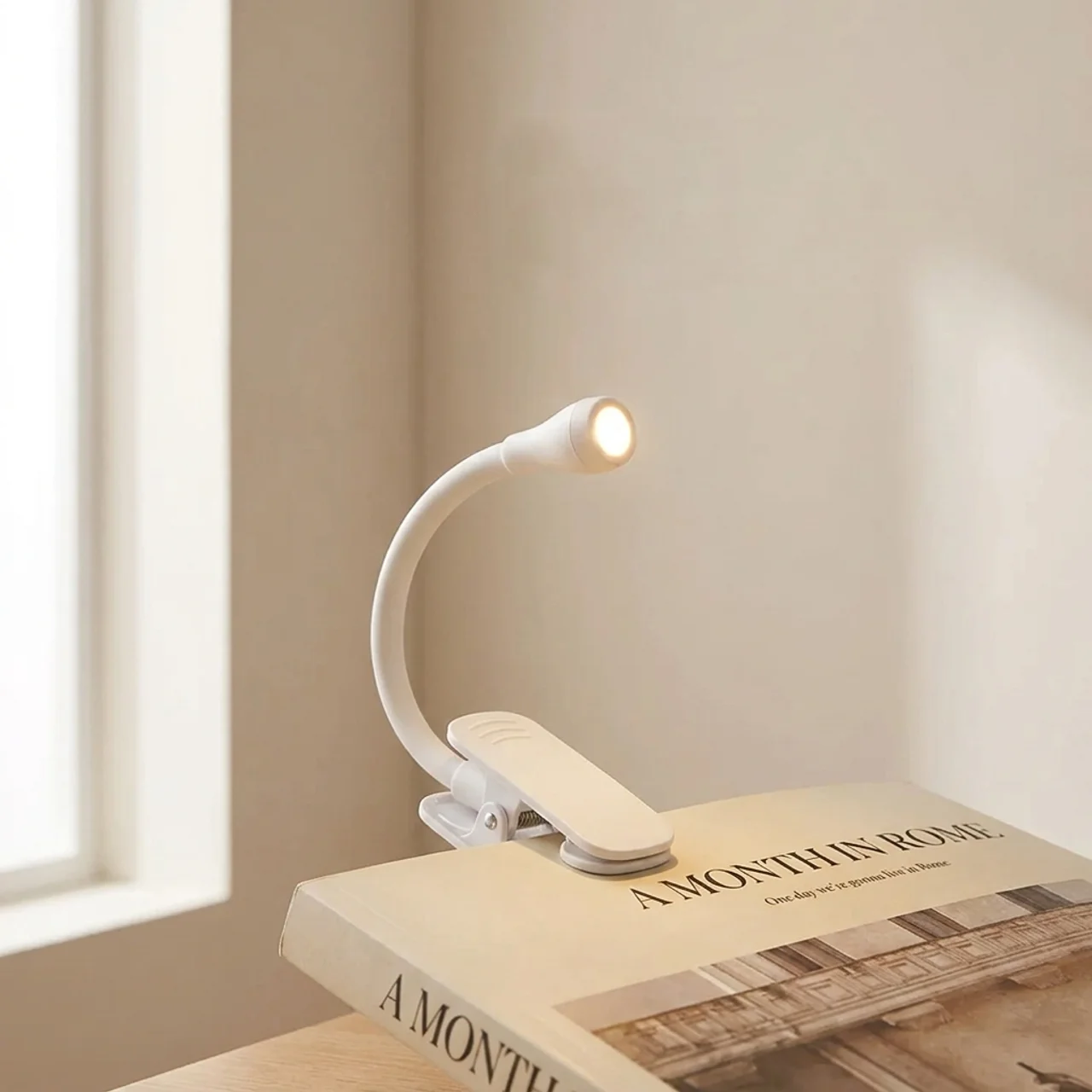 Reading lamp on a book with a soft glow in a room setting