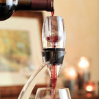 Red wine being poured into a wine decanter with a blurred background