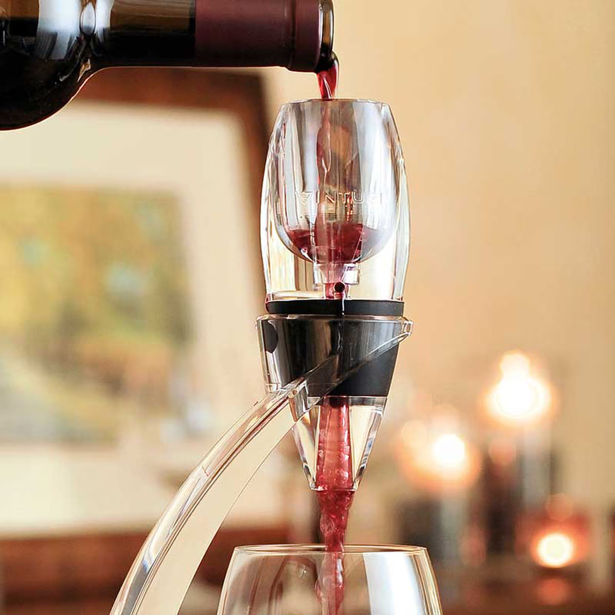 Red wine being poured into a wine decanter with a blurred background