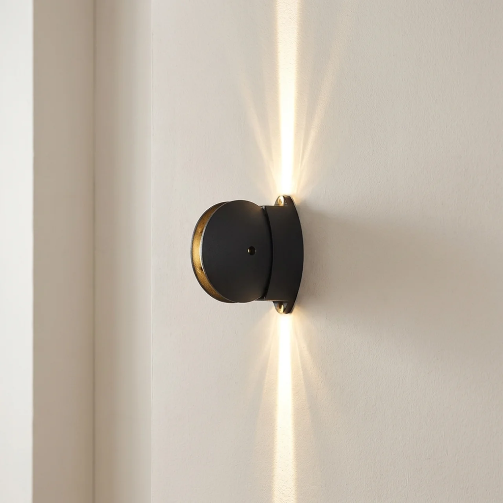Modern wall-mounted light fixture on a neutral wall