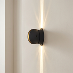 Modern wall-mounted light fixture on a neutral wall