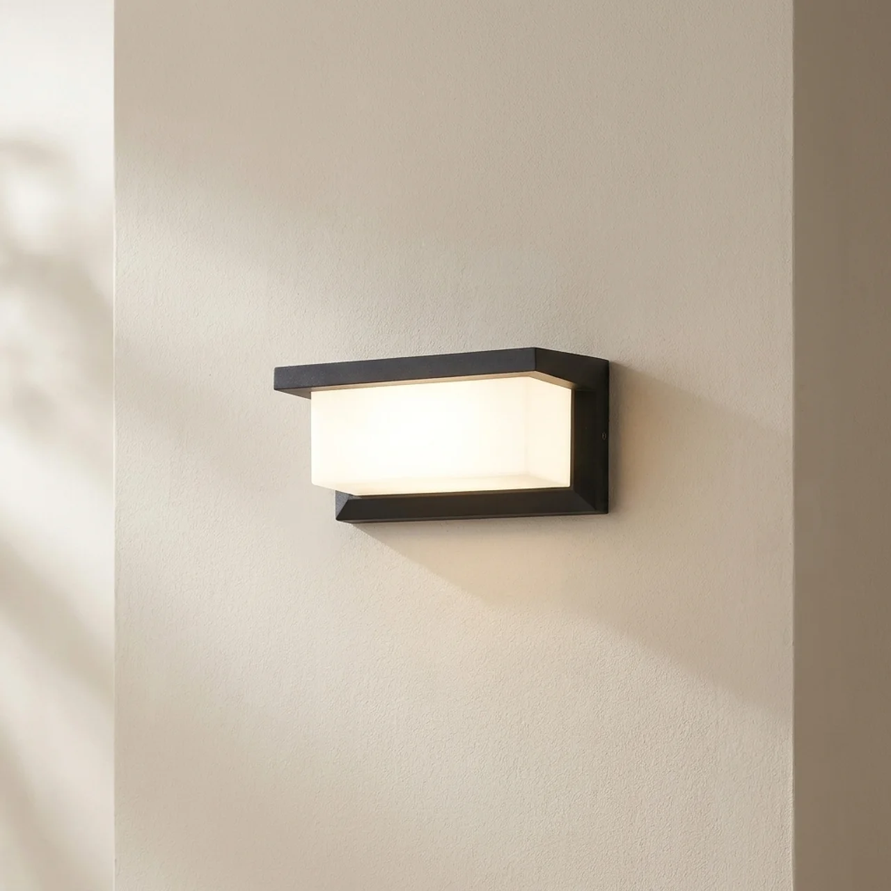Modern wall-mounted light fixture on a neutral wall