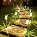 Solar pathway lights illuminating a set of outdoor steps on a grassy area.